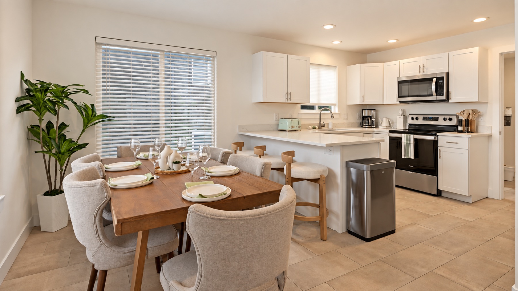 The kitchen opens straight onto the table, so whoever cooks stays in the conversation.