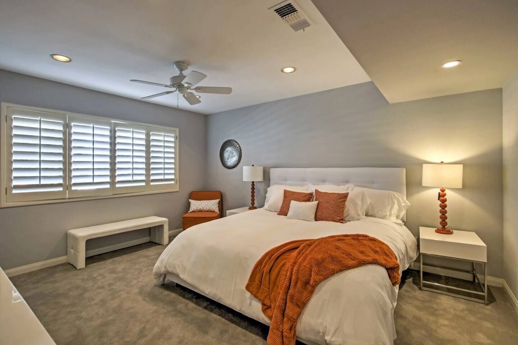 Suite two — king bed with an orange throw