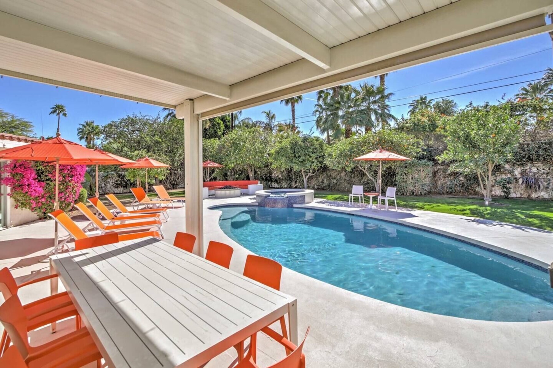 The covered patio — outdoor dining table beside the pool