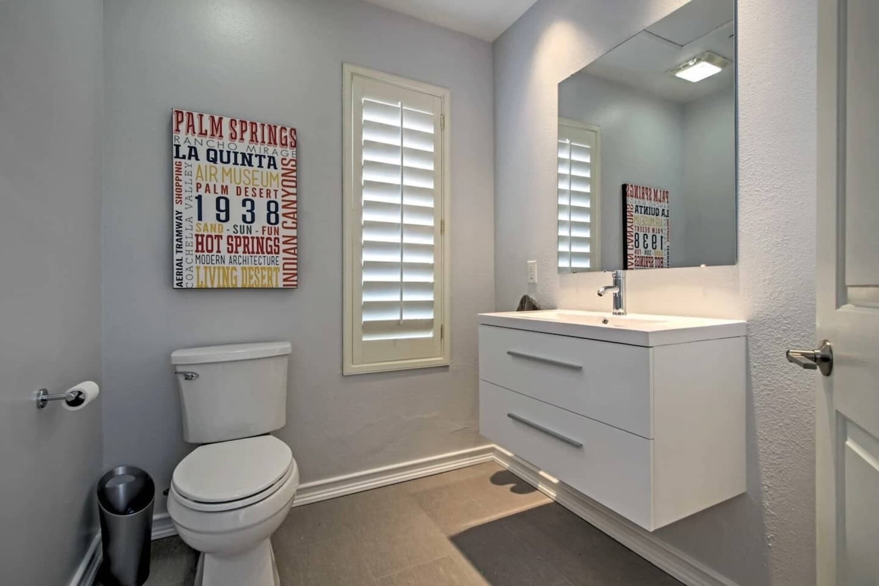 The powder room with a vintage Palm Springs sign
