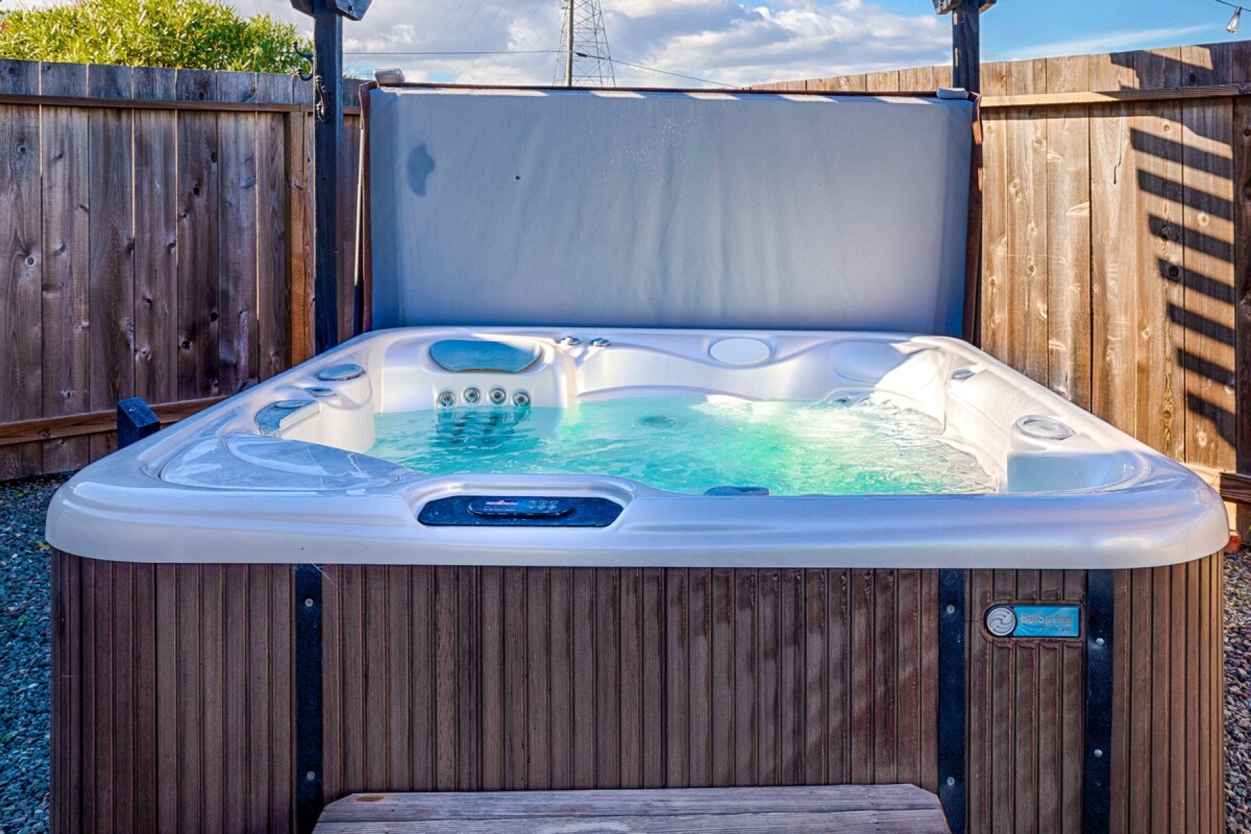 The hot tub, fenced for privacy