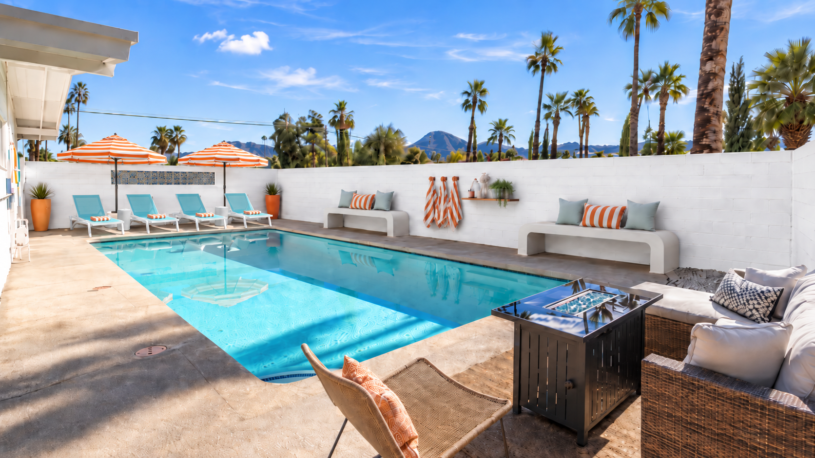 Atomic Kat House — turquoise pool, white block walls, palms and desert mountains